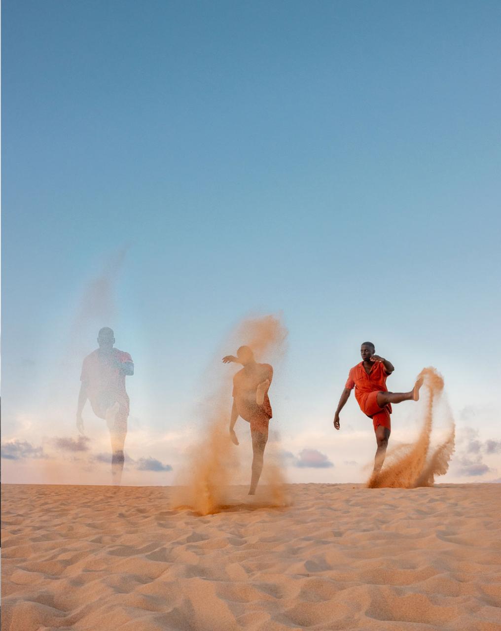 Man kicking sand