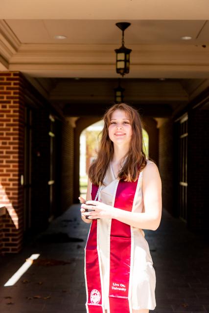 Student with graduation stoll and cap 