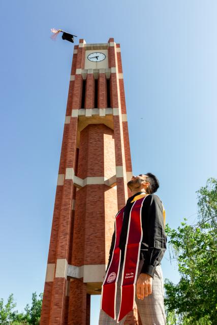 Student with graduation stoll and cap 